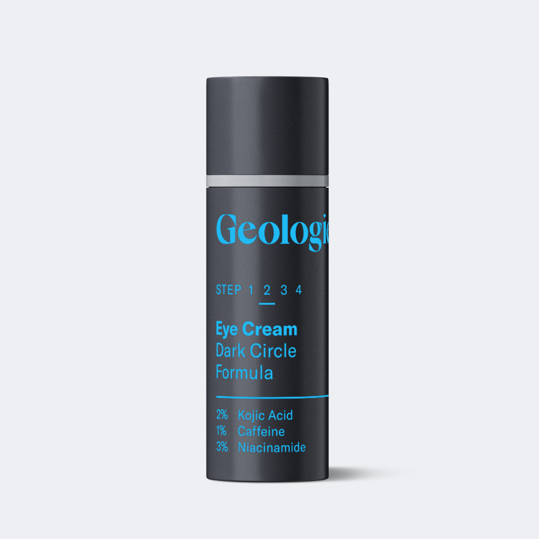 A black and blue cylindrical container labeled Geologie Eye Cream - Dark Circle Formula, containing 2% Kojic Acid, 1% Caffeine, and 3% Niacinamide. Packed with potent antioxidants, this eye cream targets dark circles effectively.